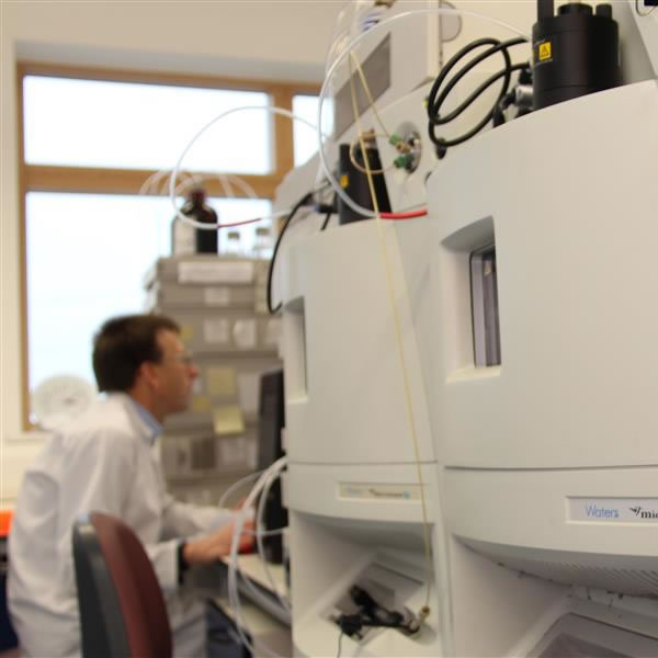 Scientist using analytical equipment to evaluate a sample